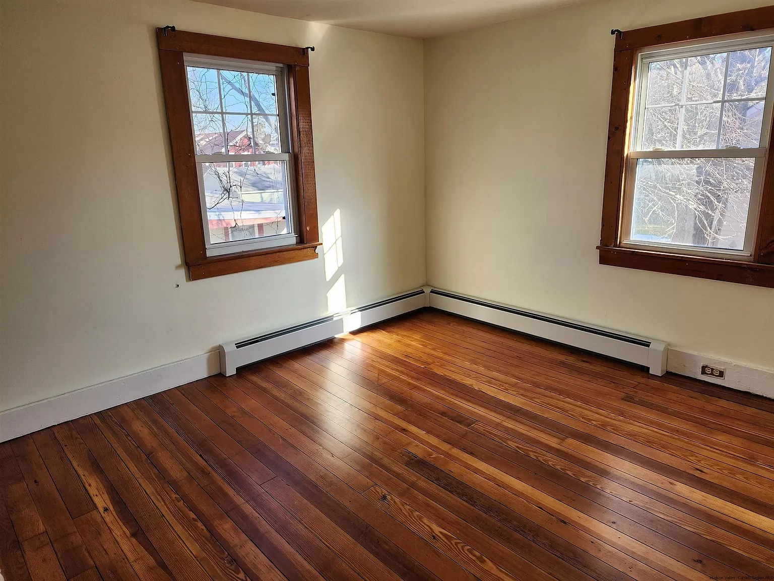 Polished wood flooring and matching window trim